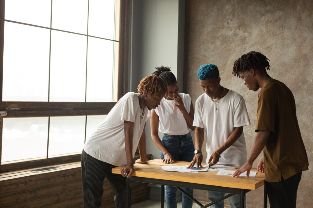 focused black coworkers discussing project